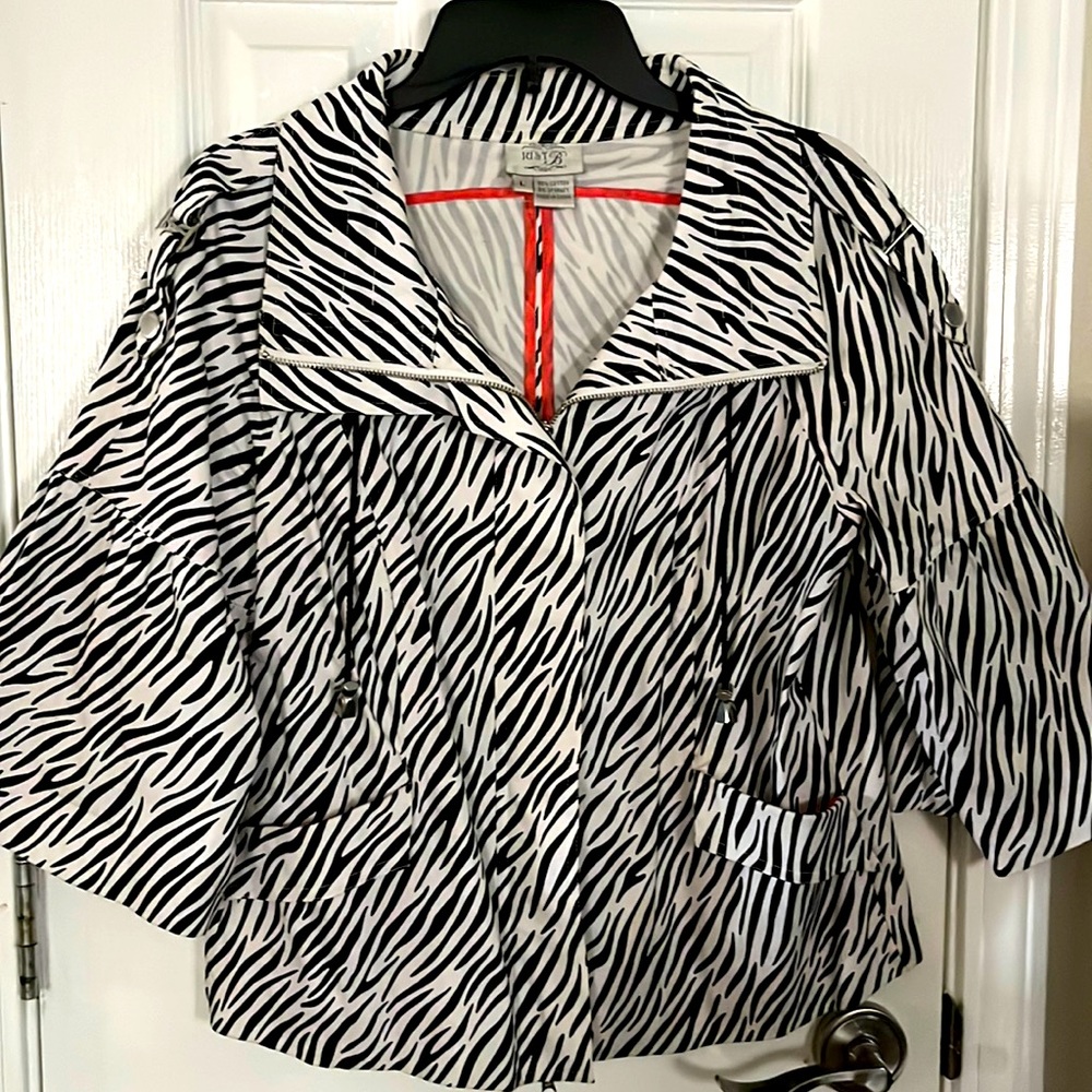 Large black and white striped short jacket with pink highlights.